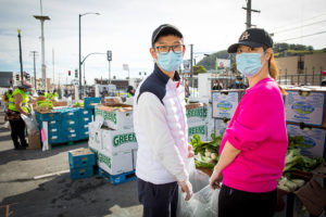 Mother and son duo volunteer at a food pantry.