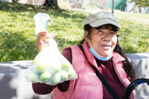 Maria holding up tomatillos