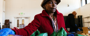 a woman filling grocery bags with food