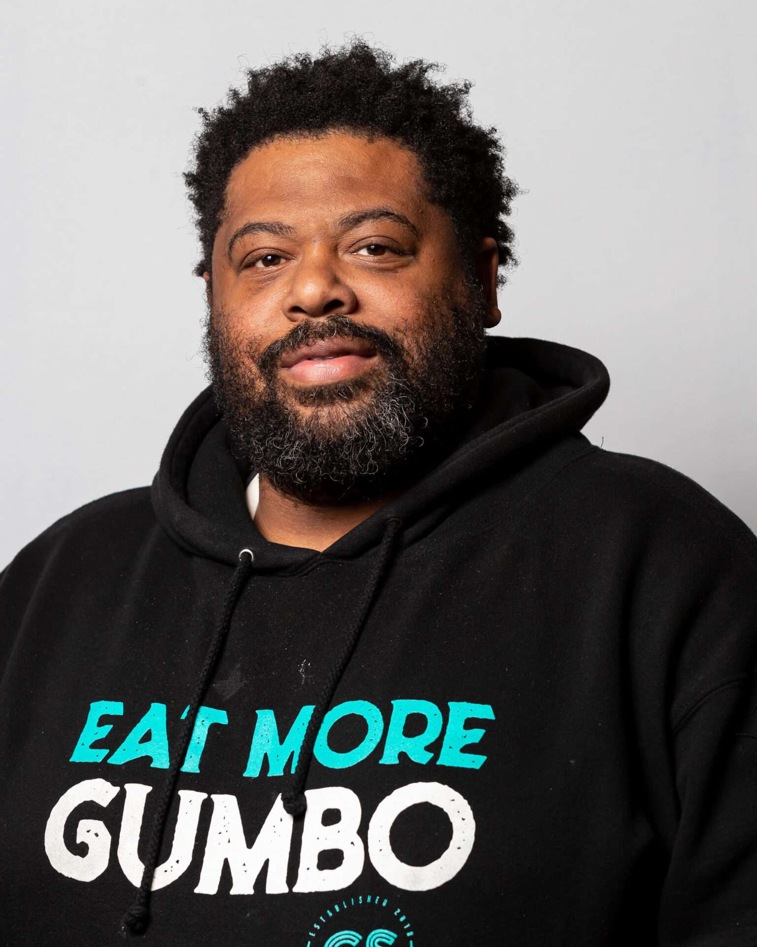 Dontaye Ball, owner of Gumbo Social, wears a hoodie emblazoned with "Eat More Gumbo."