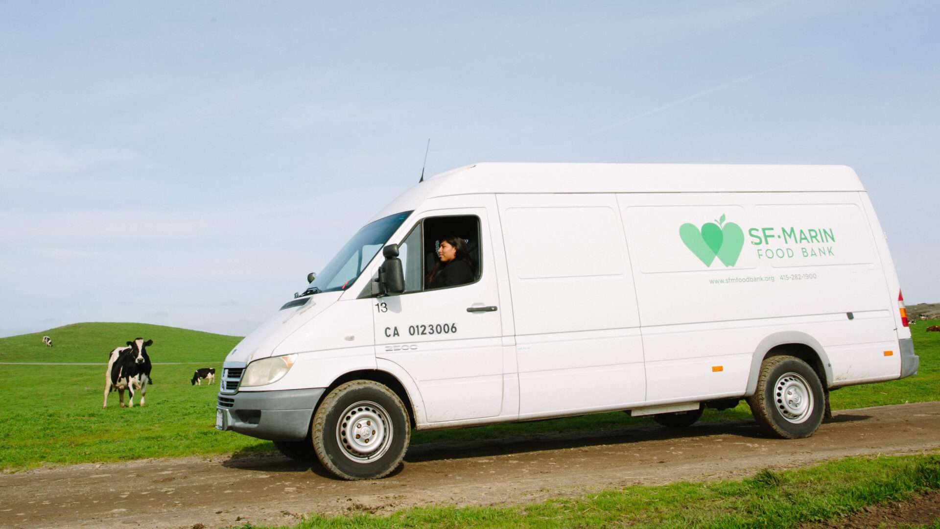 A San Francisco-Marin Food Bank branded van drives through the Marin hills. 