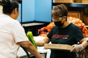 a woman handing out celery